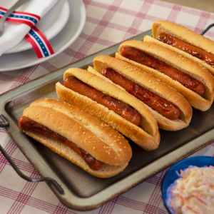 BBQ'd hotdogs on a picnic table